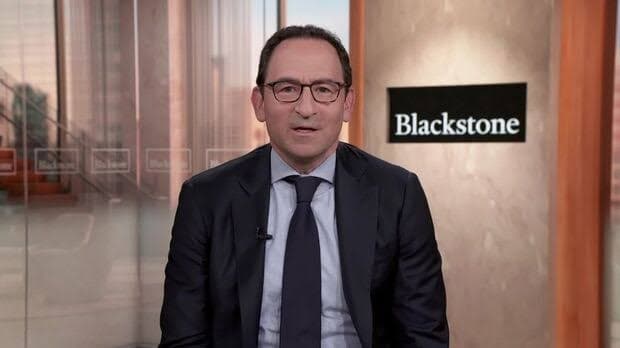 Blackstone President Jon Gray during a television interview with the Blackstone logo behind him