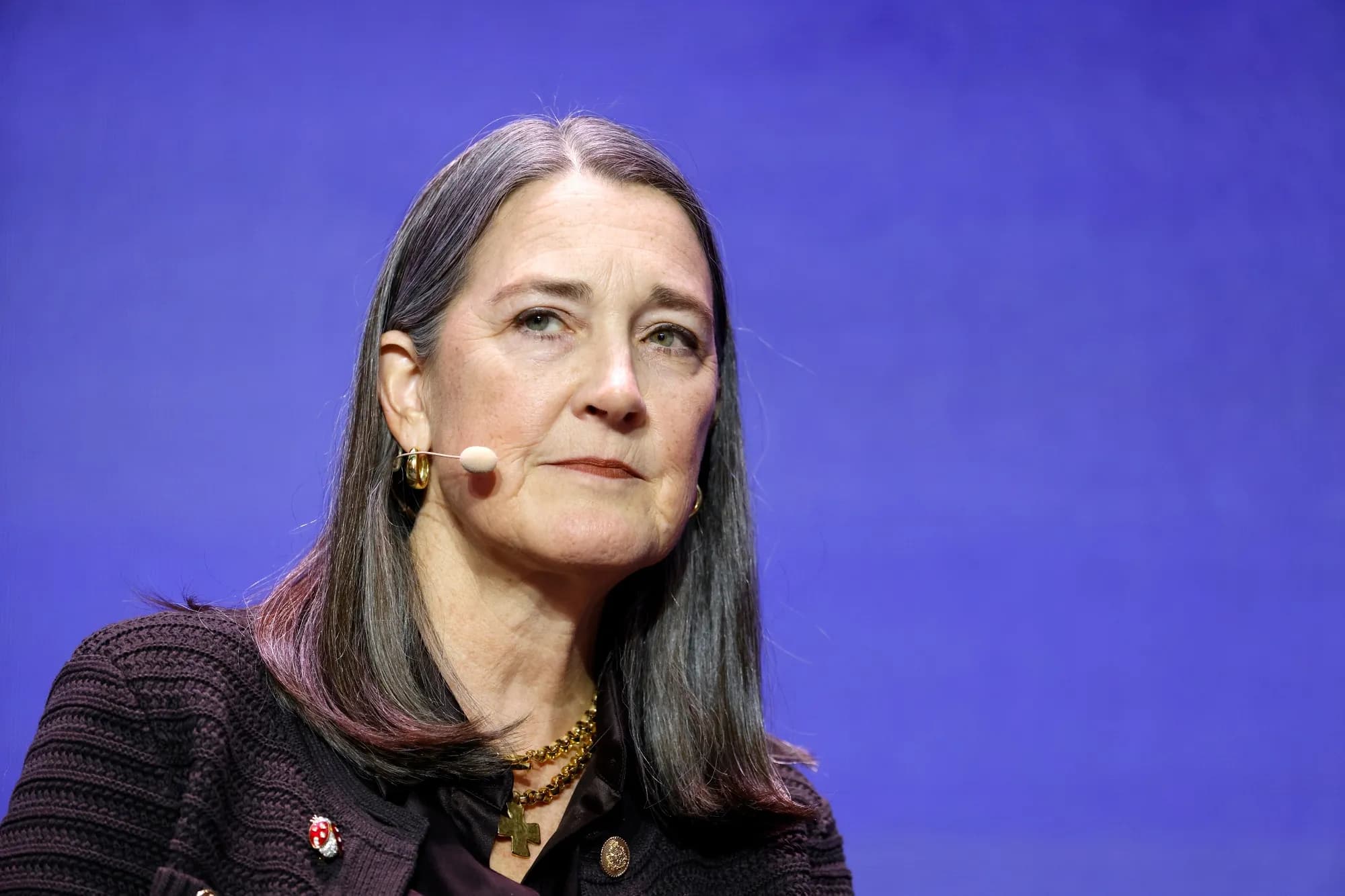 PG&E CEO Patti Poppe speaking on stage during a conference interview