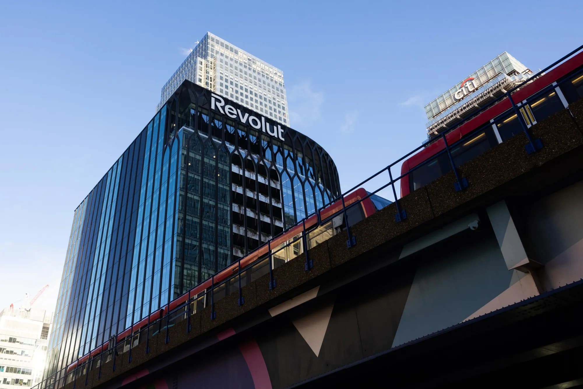 The Revolut sign on a London office tower near the Citi building and Docklands Light Railway